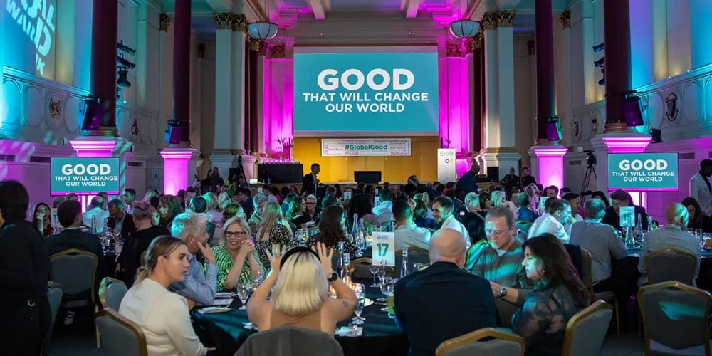 Photo of the Global Good Awards conference with the words "good that will change our world" on the big screen